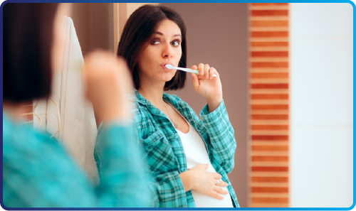 Illustration of a pregnant person holding their mouth, indicating dental pain.