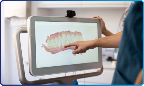 woman touching a computer screen with an image of teeth